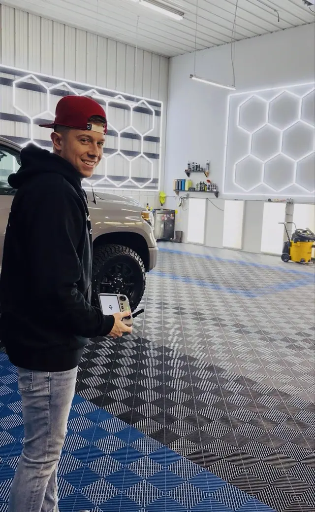 Drew Pitts filming at a detailing shop